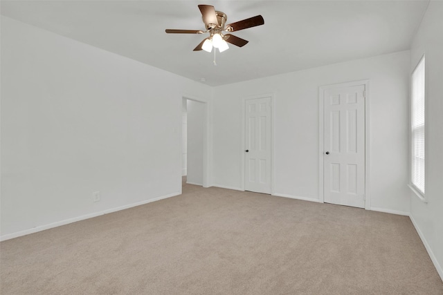 1501 W Day St, Denison, TX 75020 - unfurnished bedroom featuring light carpet, baseboards, and a ceiling fan