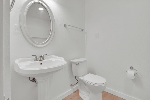 1501 W Day St, Denison, TX 75020 - half bath featuring baseboards, wood finished floors, and toilet