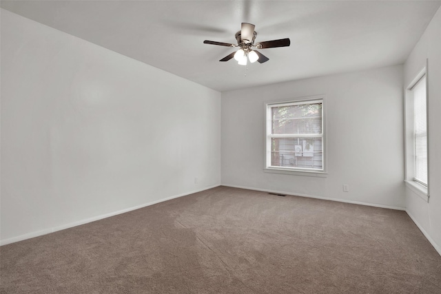 1501 W Day St, Denison, TX 75020 - carpeted empty room with plenty of natural light, ceiling fan, and baseboards
