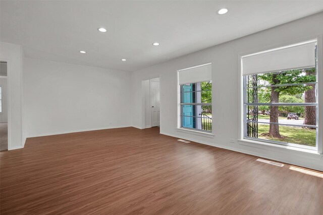 1501 W Day St, Denison, TX 75020 - unfurnished living room with wood finished floors, recessed lighting, and baseboards