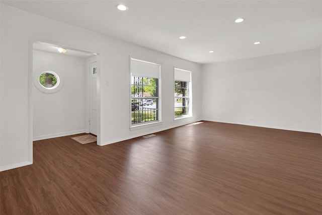 1501 W Day St, Denison, TX 75020 - empty room featuring dark wood-type flooring, baseboards, and recessed lighting