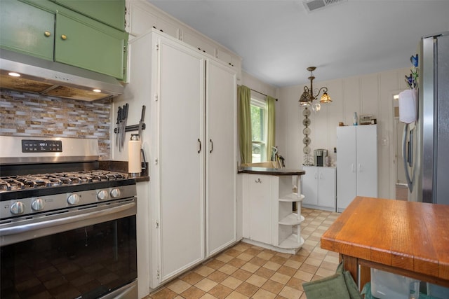 kitchen featuring appliances with stainless steel finishes, under cabinet range hood, open shelves, decorative backsplash, and decorative light fixtures