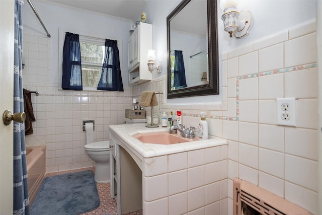 bathroom featuring tile walls, toilet, vanity, tile patterned flooring, and crown molding