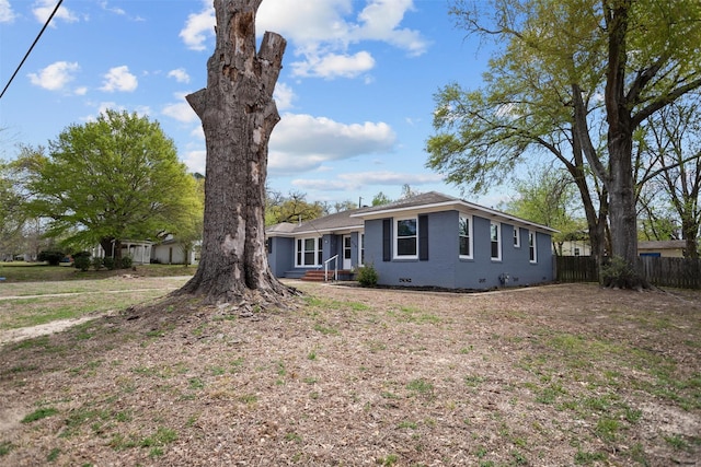 ranch-style house featuring fence and crawl space