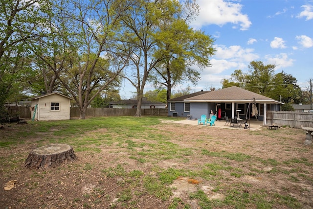 view of yard featuring a patio area, an outdoor structure, and a shed