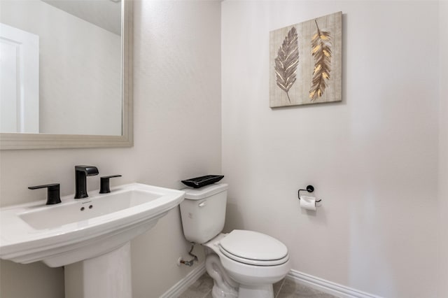 3228 Saddle Brook Rd, Celina, TX 75009 - bathroom featuring baseboards, toilet, a sink, and tile patterned flooring