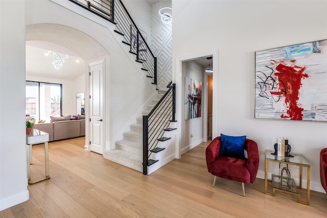 3228 Saddle Brook Rd, Celina, TX 75009 - stairs featuring wood finished floors, arched walkways, baseboards, and a high ceiling
