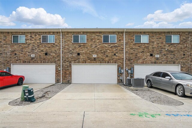 2832 Baneberry Ln, Mesquite, TX 75150 - view of front facade featuring a garage, driveway, central air condition unit, and brick siding
