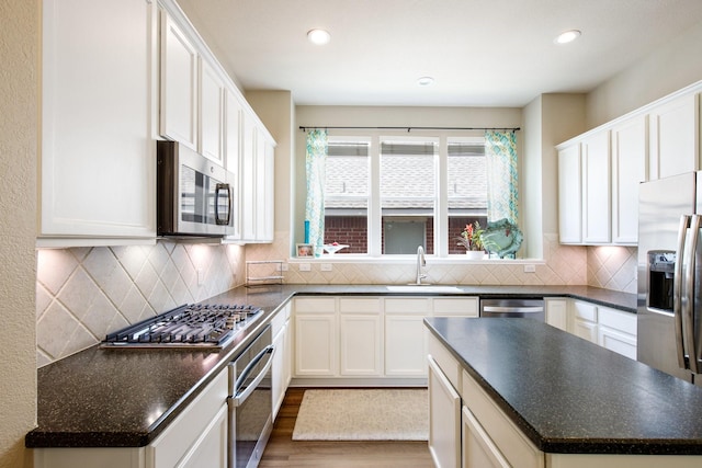 9121 Rio Blanco Dr, Frisco, TX 75033 - kitchen with appliances with stainless steel finishes, a sink, dark countertops, and recessed lighting