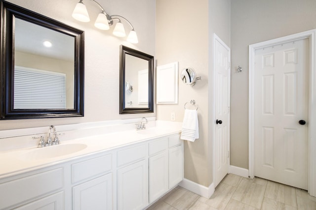 9121 Rio Blanco Dr, Frisco, TX 75033 - bathroom featuring baseboards and double vanity