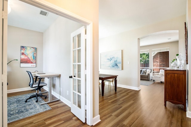 9121 Rio Blanco Dr, Frisco, TX 75033 - office area with arched walkways, wood finished floors, and baseboards