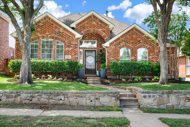 9121 Rio Blanco Dr, Frisco, TX 75033 - view of front of home with brick siding, roof with shingles, and a front yard