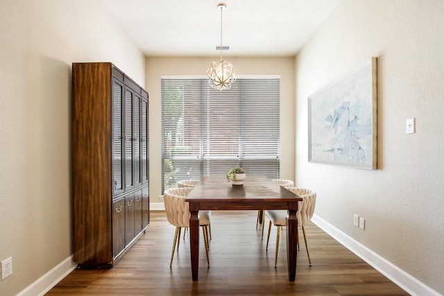 9121 Rio Blanco Dr, Frisco, TX 75033 - dining room featuring a chandelier, dark wood-style flooring, and baseboards