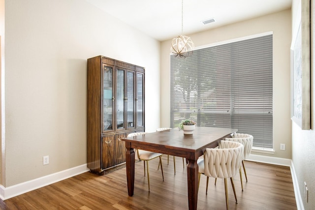9121 Rio Blanco Dr, Frisco, TX 75033 - dining room featuring a chandelier, wood finished floors, and baseboards