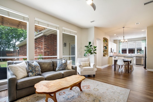 9121 Rio Blanco Dr, Frisco, TX 75033 - living area with a chandelier, dark wood-type flooring, baseboards, and recessed lighting