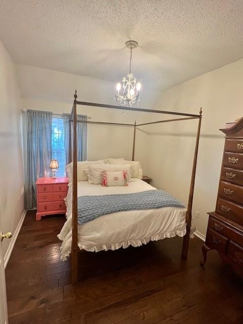 2904 Branch Hollow Cir, Flower Mound, TX 75028 - bedroom with a textured ceiling, hardwood / wood-style flooring, baseboards, and a chandelier
