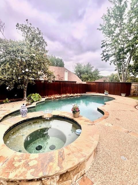 2904 Branch Hollow Cir, Flower Mound, TX 75028 - view of swimming pool featuring a fenced backyard and a pool with connected hot tub