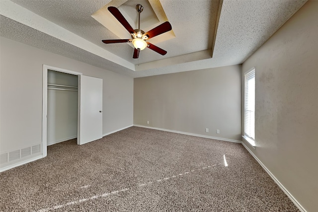 2800 Glen Forest Ln, Plano, TX 75023 - unfurnished bedroom featuring carpet, a textured ceiling, a raised ceiling, baseboards, and a closet