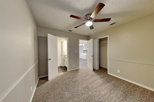 2800 Glen Forest Ln, Plano, TX 75023 - unfurnished bedroom with carpet flooring, a textured ceiling, wainscoting, a closet, and ceiling fan