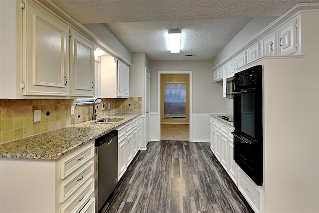 2800 Glen Forest Ln, Plano, TX 75023 - kitchen with a sink, black appliances, a textured ceiling, dark wood-style floors, and light stone countertops