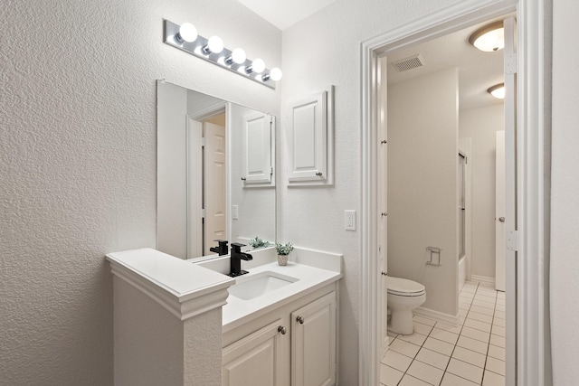 2445 Sky Harbor Dr, Plano, TX 75025 - bathroom with tile patterned flooring, toilet, vanity, bathing tub / shower combination, and a textured wall