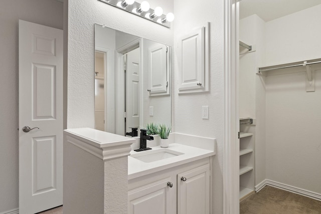 2445 Sky Harbor Dr, Plano, TX 75025 - bathroom featuring vanity and a walk in closet