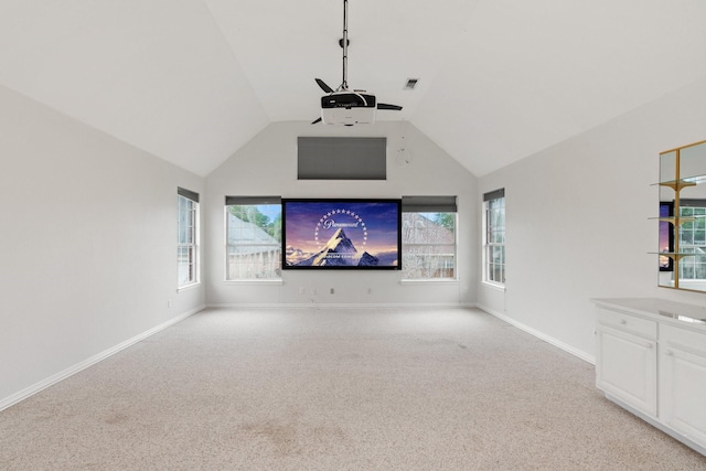 2445 Sky Harbor Dr, Plano, TX 75025 - home theater with light carpet, a ceiling fan, and vaulted ceiling