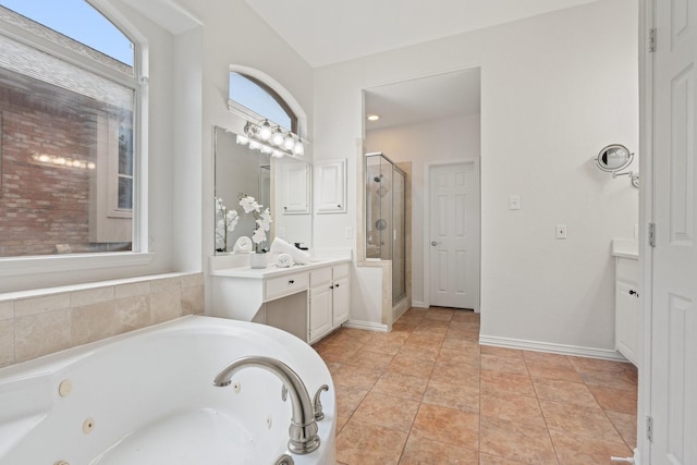 2445 Sky Harbor Dr, Plano, TX 75025 - full bath with a shower stall, a jetted tub, vanity, and baseboards