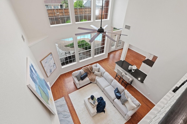 2445 Sky Harbor Dr, Plano, TX 75025 - living room with a towering ceiling, a ceiling fan, and wood finished floors