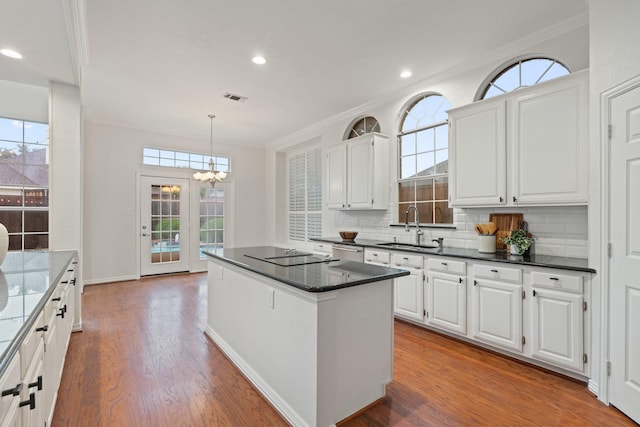 2445 Sky Harbor Dr, Plano, TX 75025 - kitchen featuring dishwasher, white cabinets, a chandelier, crown molding, and decorative backsplash