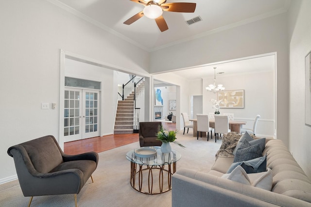 2445 Sky Harbor Dr, Plano, TX 75025 - carpeted living room with french doors, stairs, crown molding, a ceiling fan, and a chandelier