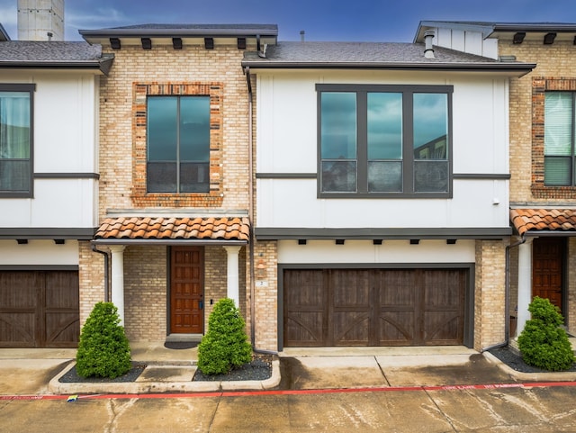 13900 Noel Rd Unit 2, Dallas, TX 75240 - multi unit property featuring a garage, driveway, and brick siding