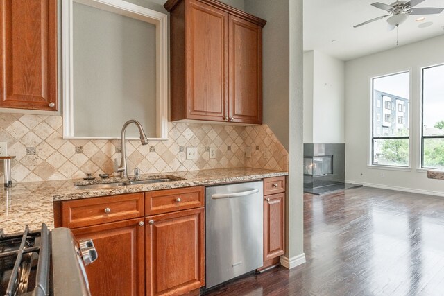 13900 Noel Rd Unit 2, Dallas, TX 75240 - kitchen featuring stainless steel appliances, a sink, dark wood-style flooring, a ceiling fan, and light stone counters