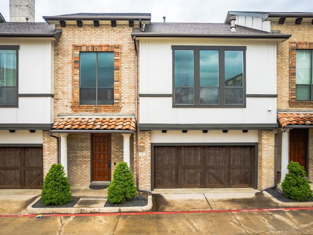 13900 Noel Rd Unit 2, Dallas, TX 75240 - townhome / multi-family property featuring an attached garage and brick siding