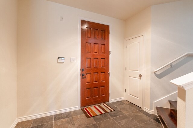 13900 Noel Rd Unit 2, Dallas, TX 75240 - foyer entrance with baseboards and stairway