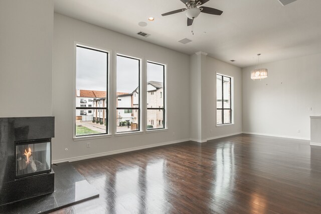 13900 Noel Rd Unit 2, Dallas, TX 75240 - unfurnished living room with dark wood-type flooring, ceiling fan, baseboards, and a multi sided fireplace