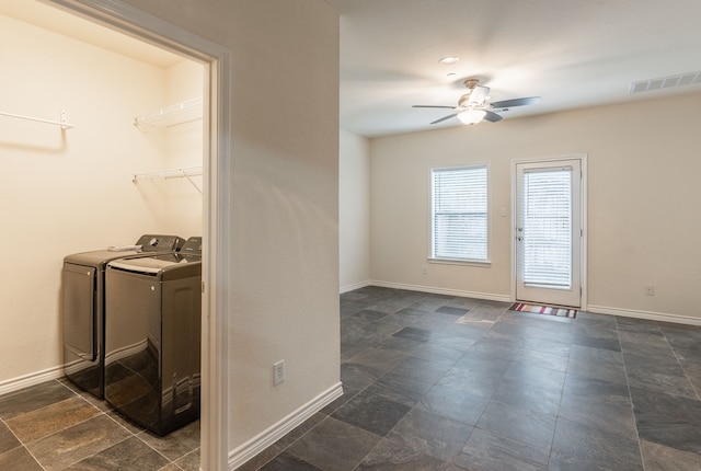13900 Noel Rd Unit 2, Dallas, TX 75240 - laundry area featuring separate washer and dryer, a ceiling fan, baseboards, and dark stone finish floors