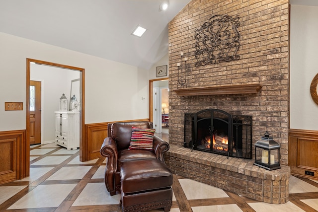 508 Quail Crest Dr, Colleyville, TX 76034 - living room featuring inlaid floor details, a wainscoted wall, a fireplace, and high vaulted ceiling