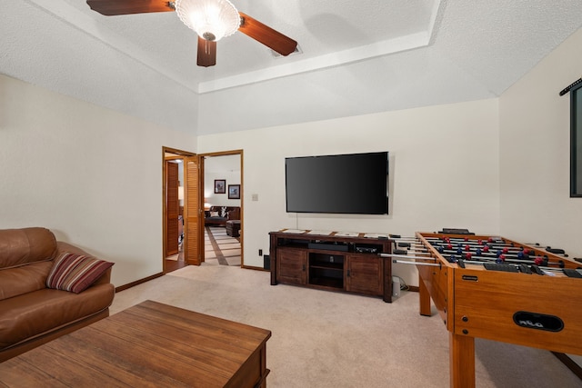 508 Quail Crest Dr, Colleyville, TX 76034 - playroom featuring light colored carpet, ceiling fan, a tray ceiling, and a textured ceiling