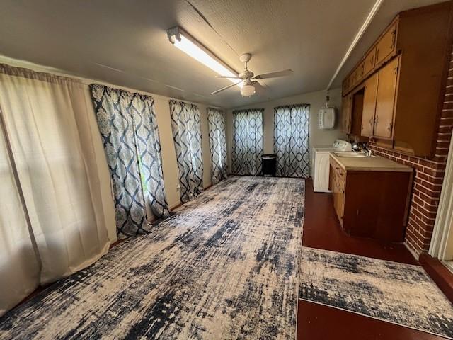 kitchen with ceiling fan and brown cabinets