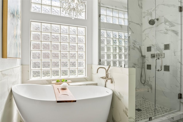 2512 Mona Vale Rd, Trophy Club, TX 76262 - full bathroom with tile walls, a marble finish shower, plenty of natural light, a soaking tub, and wainscoting