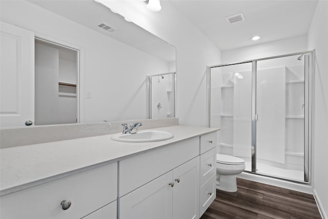 1802 Marquette Rd, Princeton, TX 75407 - bathroom with a shower stall, toilet, wood finished floors, vanity, and recessed lighting