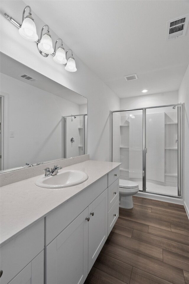 1802 Marquette Rd, Princeton, TX 75407 - bathroom with toilet, a stall shower, wood finished floors, and vanity