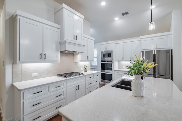 14601 Donner Trl, Fort Worth, TX 76262 - kitchen with appliances with stainless steel finishes, decorative backsplash, white cabinets, lofted ceiling, and recessed lighting