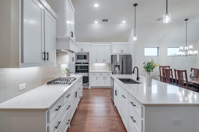 14601 Donner Trl, Fort Worth, TX 76262 - kitchen featuring appliances with stainless steel finishes, a sink, a chandelier, light countertops, and dark wood-type flooring