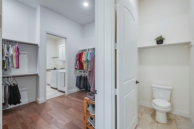 14601 Donner Trl, Fort Worth, TX 76262 - bathroom with a walk in closet, independent washer and dryer, toilet, and baseboards