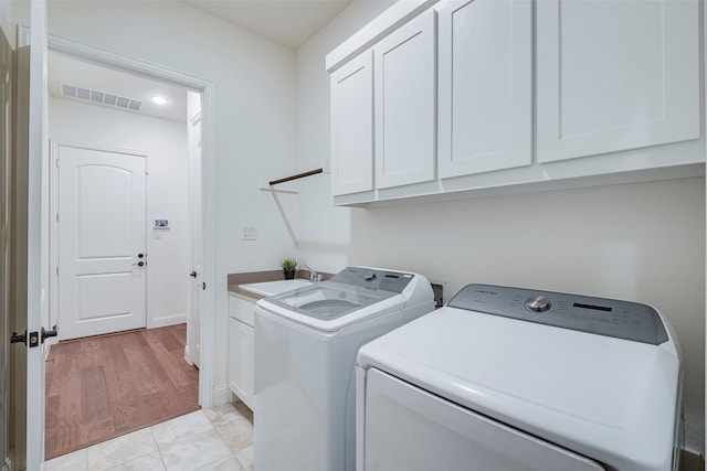 14601 Donner Trl, Fort Worth, TX 76262 - clothes washing area featuring cabinet space, independent washer and dryer, baseboards, and light wood-type flooring