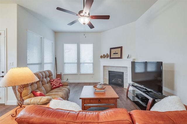14601 Donner Trl, Fort Worth, TX 76262 - living area with wood finished floors, ceiling fan, a tiled fireplace, and baseboards