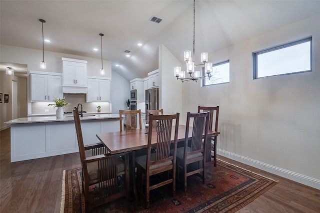 14601 Donner Trl, Fort Worth, TX 76262 - dining area with a chandelier, dark wood-type flooring, vaulted ceiling, and baseboards