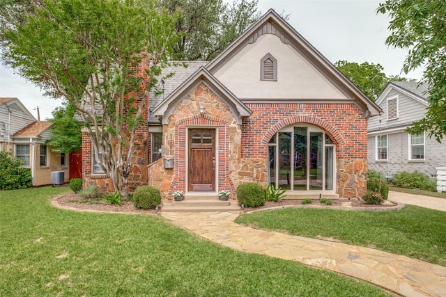 5322 Stoneleigh Ave, Dallas, TX 75235 - view of front of property with stone siding, a front yard, brick siding, and central air condition unit